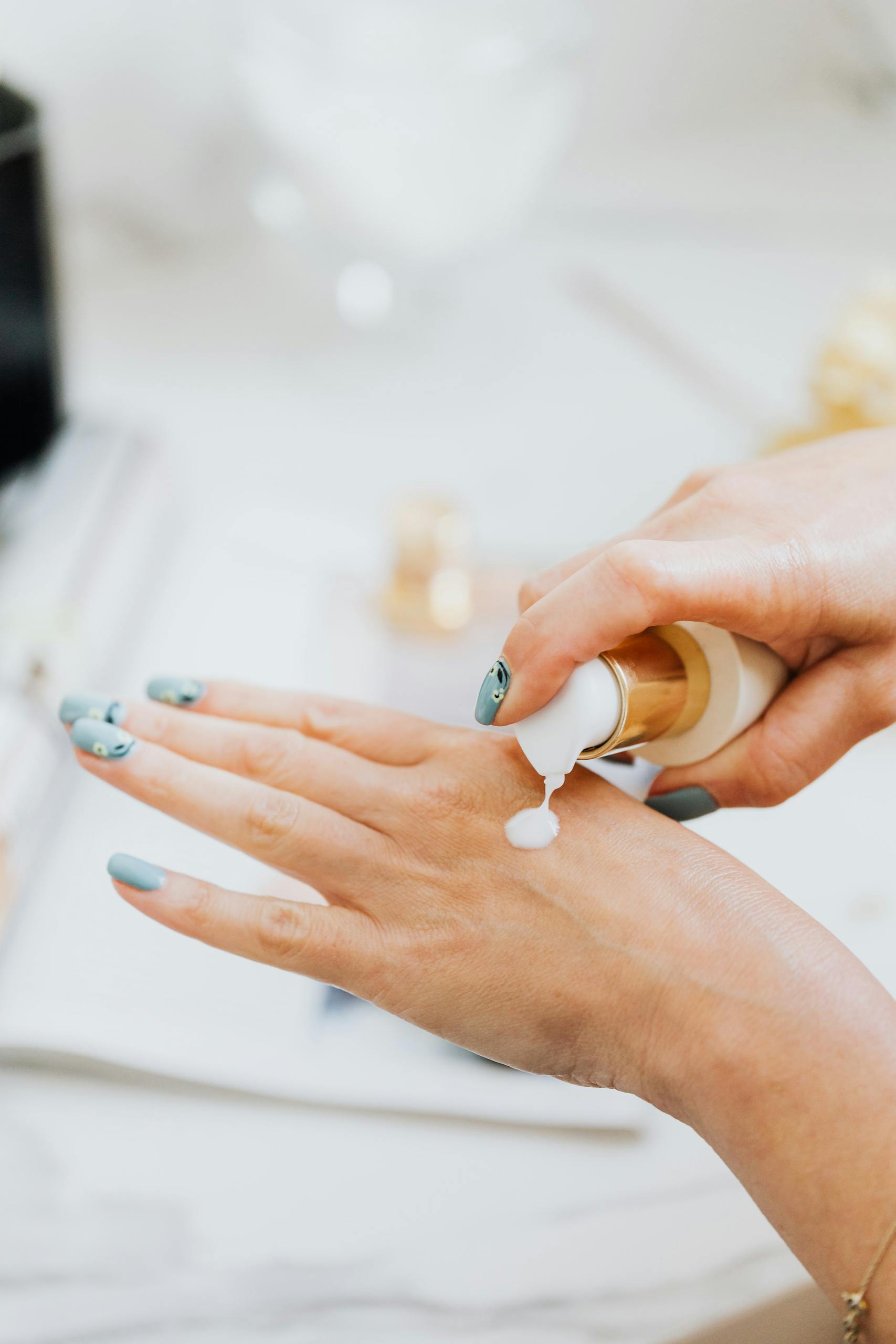 Person Wearing Silver Ring With White Manicure