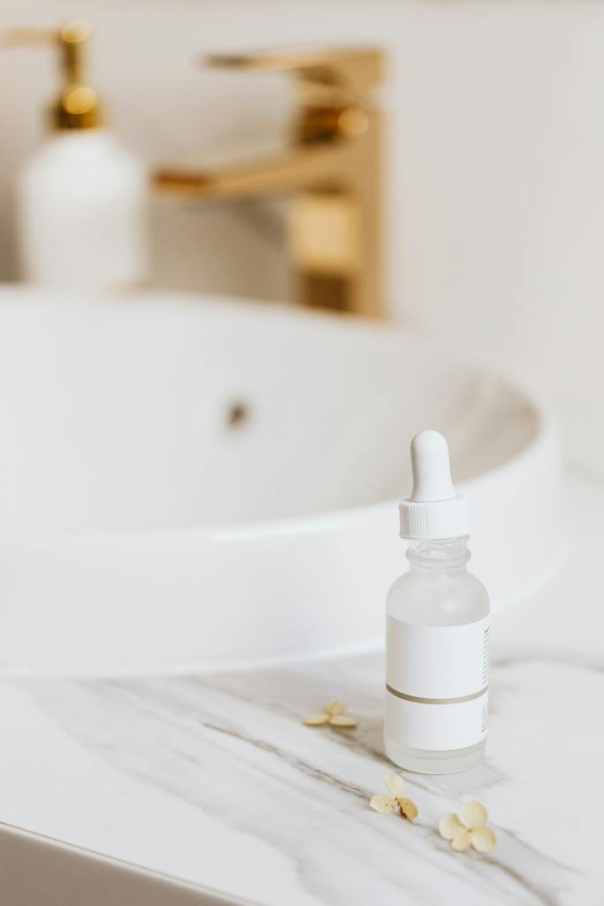 White Plastic Bottle on White Ceramic Sink