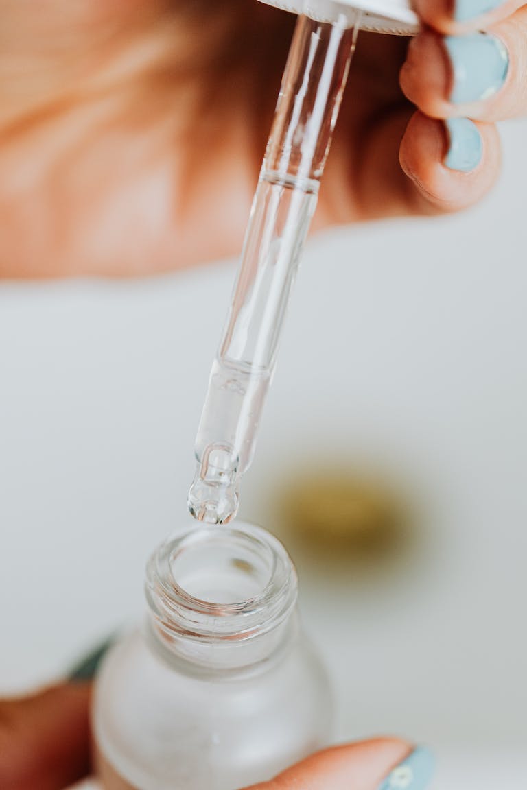 Person Holding Clear Glass Tube