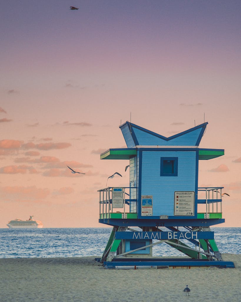 Lifeguard building on seashore against sundown sky