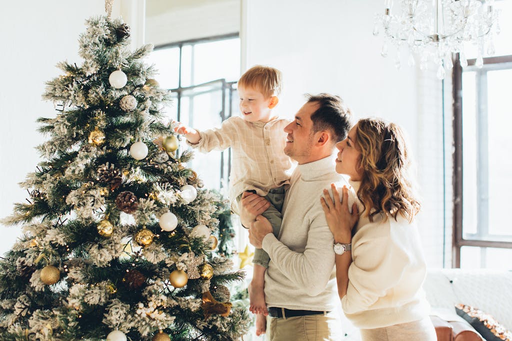 Couple with Their Son Looking at a Christmas Tree